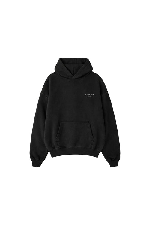Black oversized hoodie, front, with small chest logo