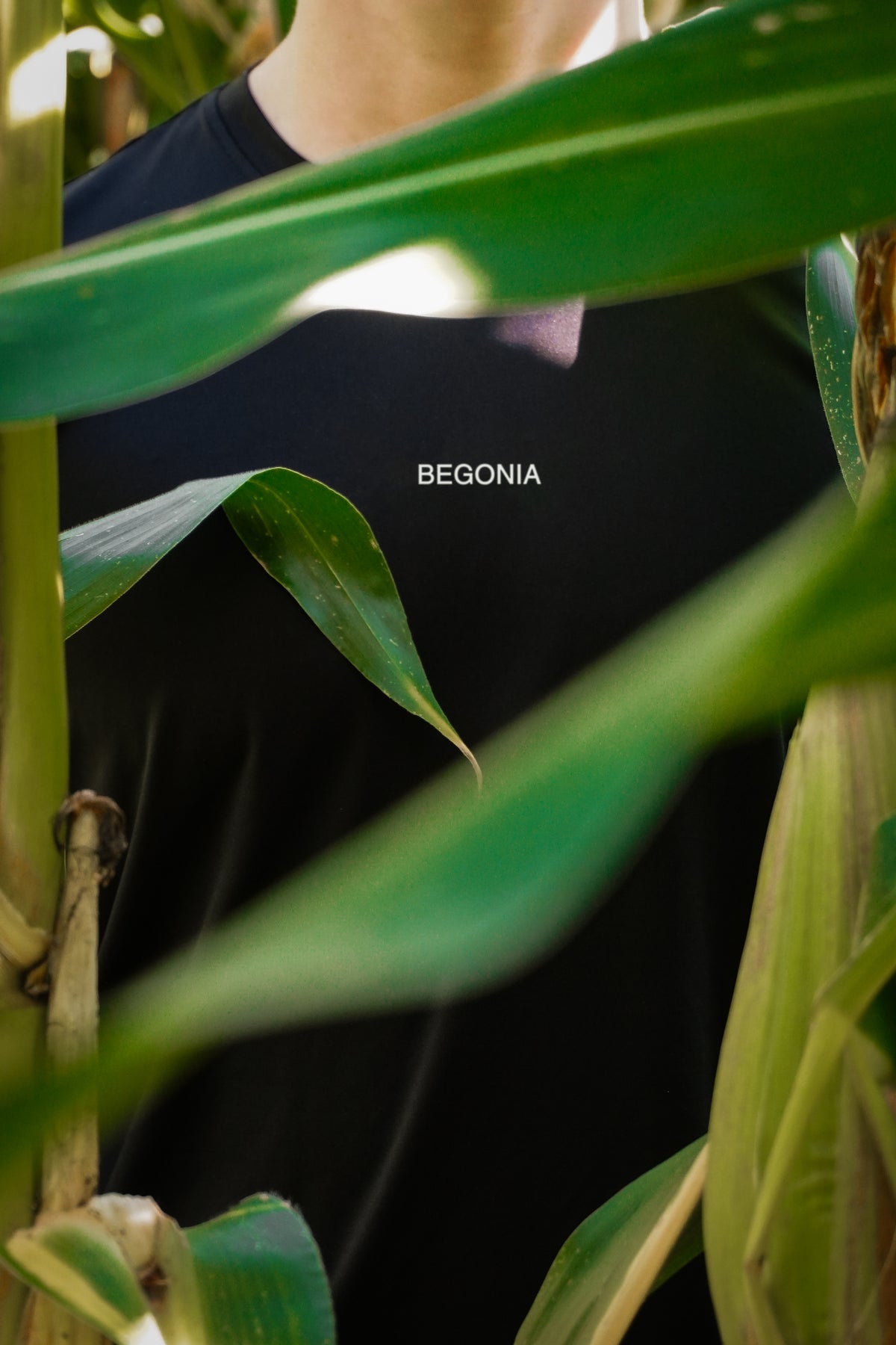 Black seamless long sleeve tee worn among cornfield leaves